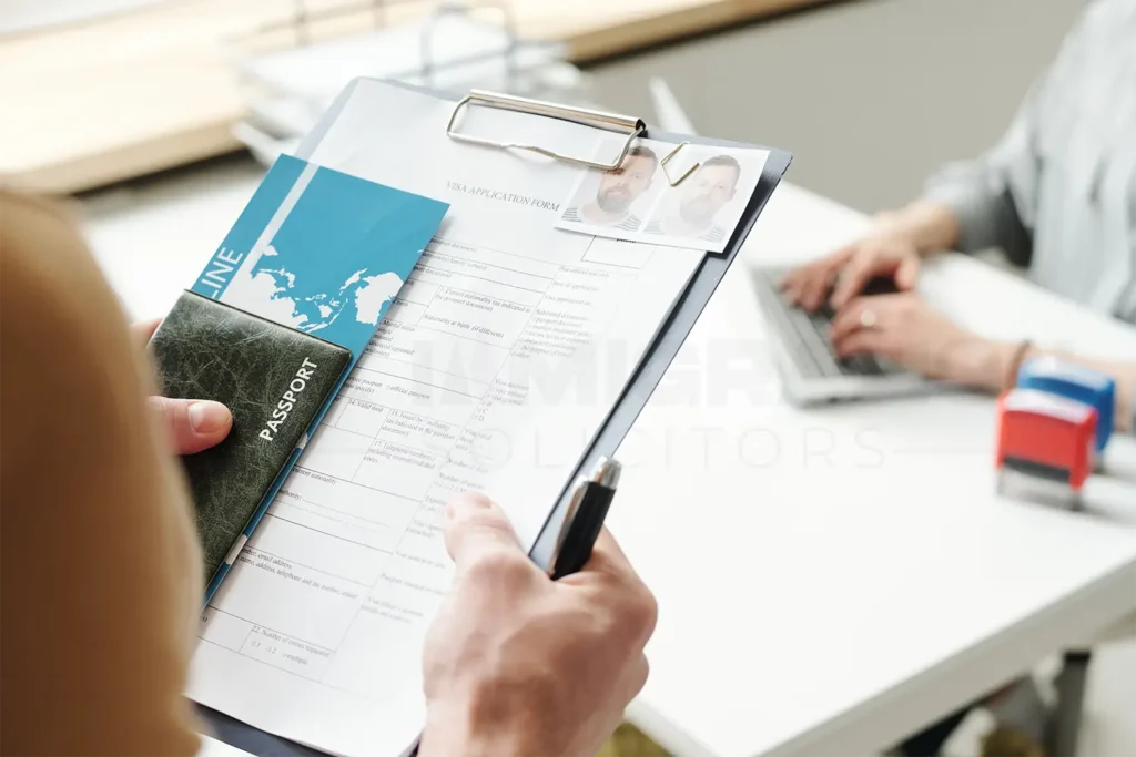 Woman holding a stack of documents for spouse visa application