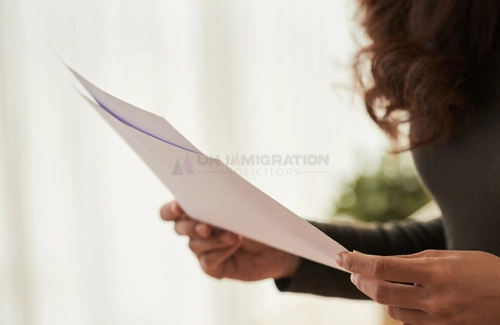 A girl holding documents to submit for UK ancestry visa.