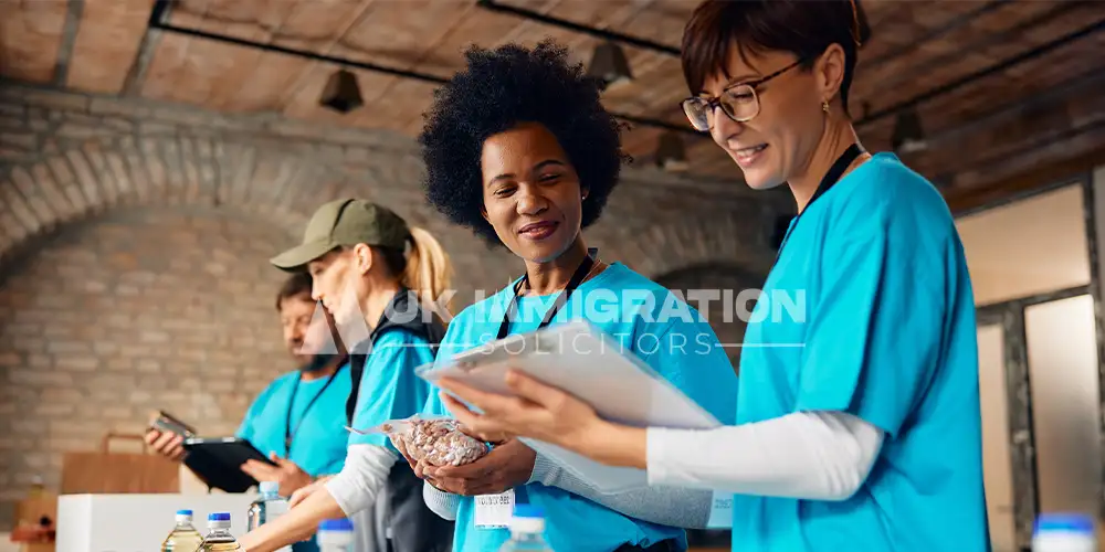 UK Charity Worker Visa 21 Doctors reviewing visa documents for UK Charity Worker Visa requirements