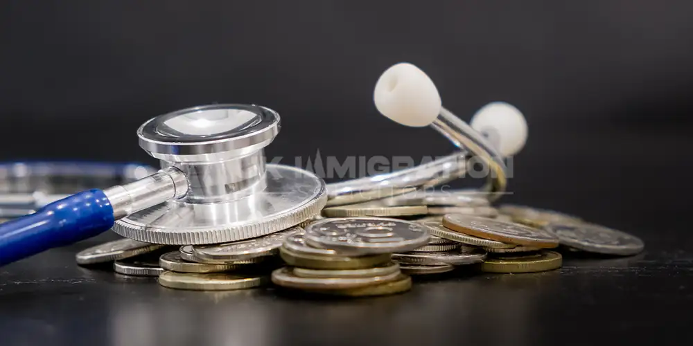 Stethoscope placed on coins symbolising UK medical treatment visa costs and healthcare expenses