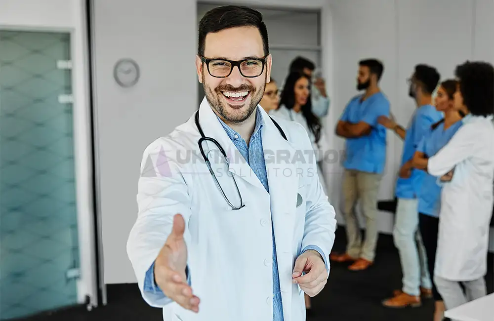 Doctor welcoming healthcare professionals in a UK hospital setting