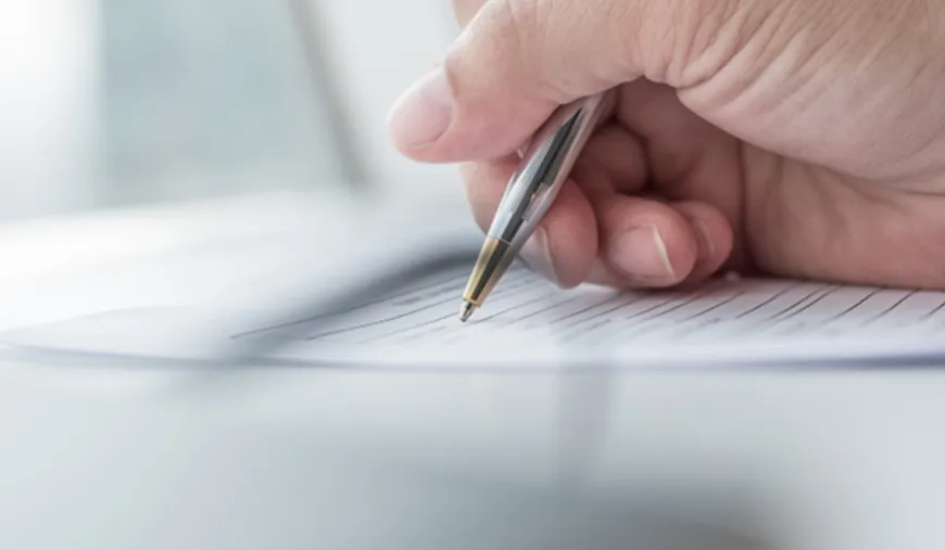 Hand signing official documents for a UK Sponsor Licence application